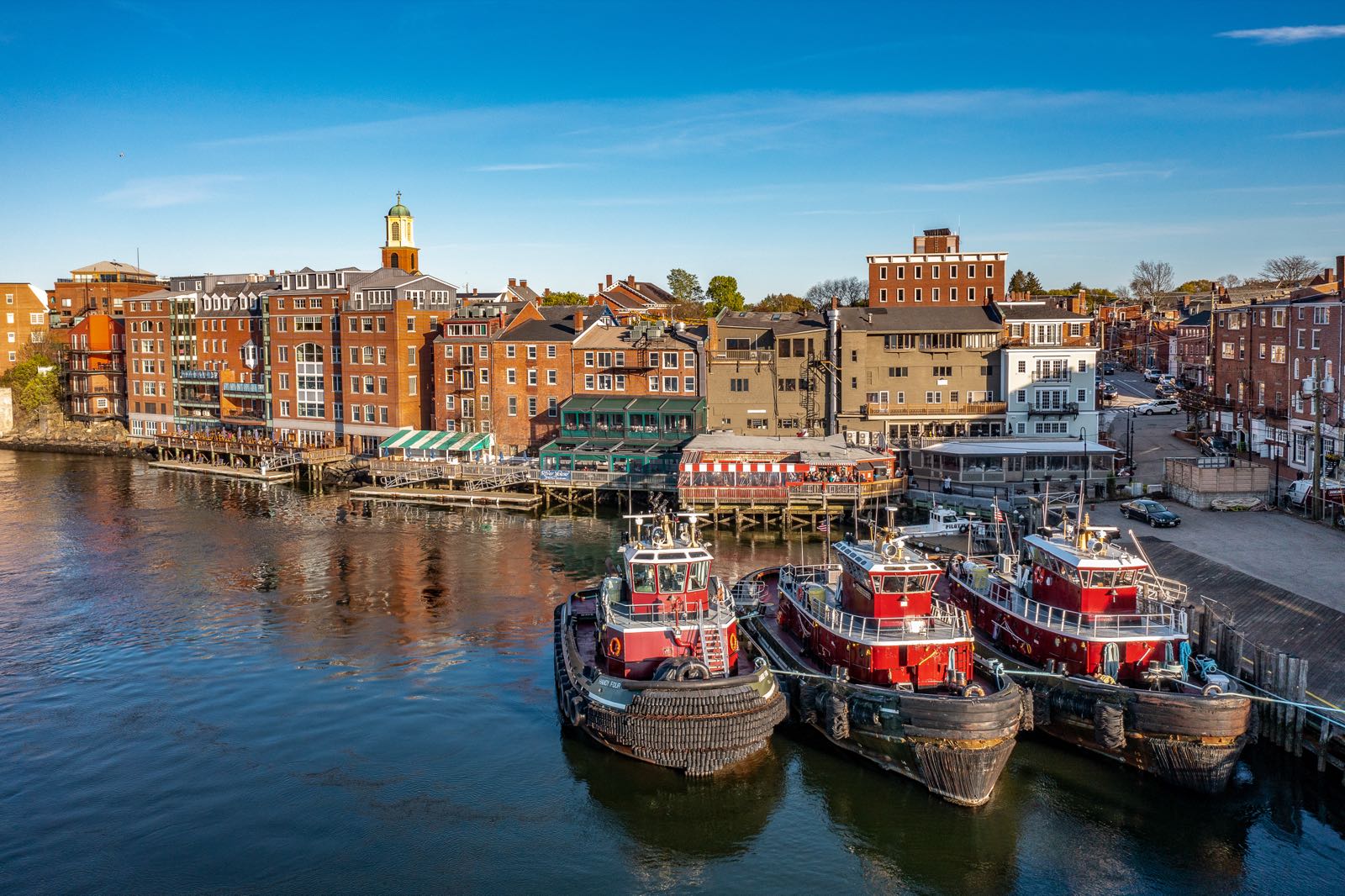 Portsmouth NH waterfront with tugboats at sunset